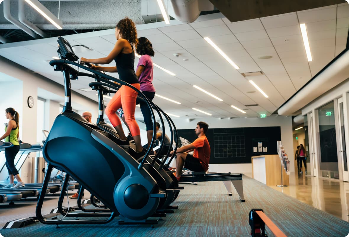 People working out using various gym equipment.